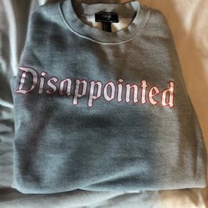 Grey crew neck “disappointed”
